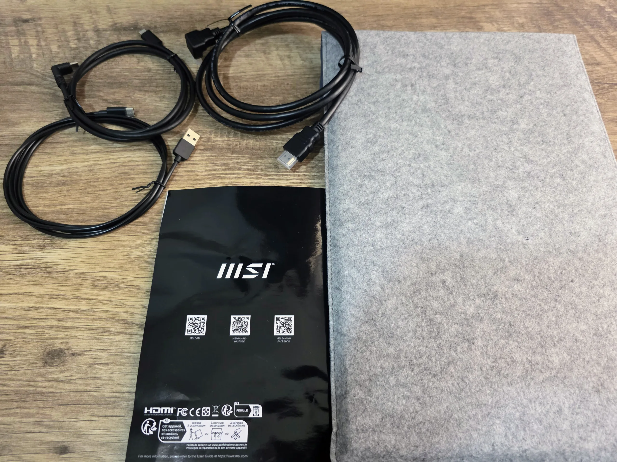 MSI Portable PRO MP165 E6 pictured alongside its cables and protective sleeve